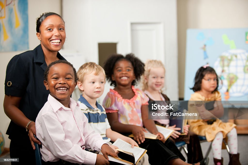 Sunday school kids A group of multi-ethnic children at Sunday School in a real church classroom. Very shallow focus. Selective focus on boy in front.  Bible Stock Photo