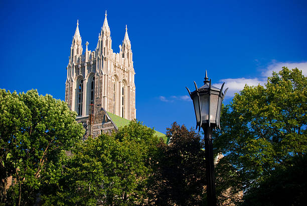 Gasson Hall on Boston College campus in Chestnut Hill, MA "Gasson Hall located on the campus of Boston College in Chestnut Hill, Massachusetts with trees and a lamppost in the foreground.Other images of Boston College:" boston college campus stock pictures, royalty-free photos & images