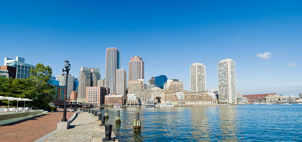 City skyline at Rowe's Wharf area of Boston, with clear blue skies on a summers day, USA