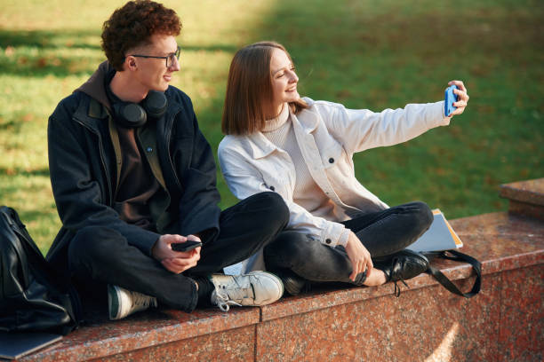 istock Taking a selfie. Two young students are together outdoors 1832225428