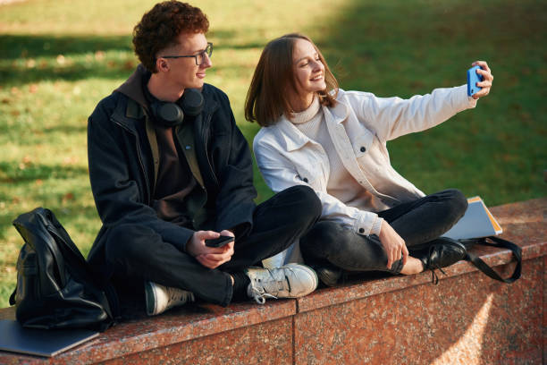istock Taking a selfie. Two young students are together outdoors 1832225936