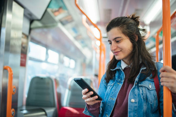 istock Young woman using the mobile phone in the public transport. 1832232823