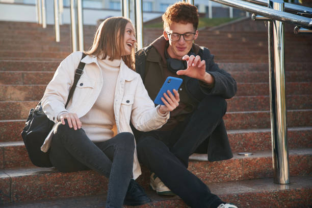 istock Having a break. Two young students are together outdoors 1832252159
