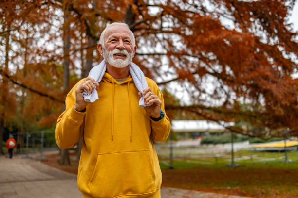 istock Happy senior man after jogging in autumn park 1832268261