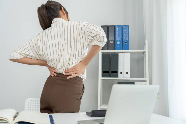 istock woman holding her lower back while and suffer from unbearable pain health and problems, chronic back pain, backache in office syndrome, scoliosis, herniated disc, muscle inflammation 1832296305