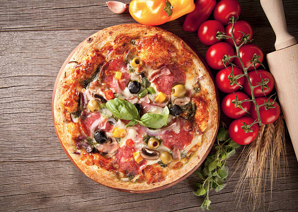 istock Delicious fresh pizza served on wooden table 183229839