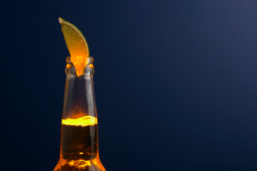 An Glowing  bottle of Mexican beer from the neck up crowned with a Lime.  Just in time for Cinco de Mayo.