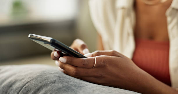 istock Hands, woman and typing on cellphone, scroll social media post and update subscription at home. Closeup, smartphone notification and download mobile games, search internet and chat to online contact 1832315919