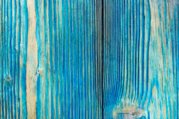 Close-up of weathered turquoise wooden planks with a textured surface. This rustic background is ideal for various design projects and home decor applications, adding a touch of character and charm.