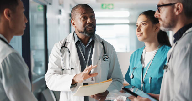 istock Doctors, nurses and team planning, hospital management and workflow discussion for schedule, advice or services. Healthcare worker, mentor and people with medical documents, clinic files and meeting 1832324470