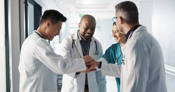 istock Doctors, nurses and hands together, applause and support, success or collaboration for hospital goals and teamwork. Medical or healthcare people clapping and stack for clinic mission and celebration 1832324481