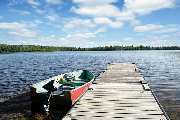 XXL fishing boat and lake fishing boat on wilderness lake with bright sky (XXL) northern ontario stock pictures, royalty-free photos & images