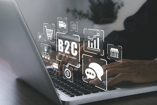 B2C, business to customer concept.marketing strategy.Businessman working on laptop computers with B2C icons. Direct marketing between businesses that sell products or services and general consumers.Shoping and selling products online.