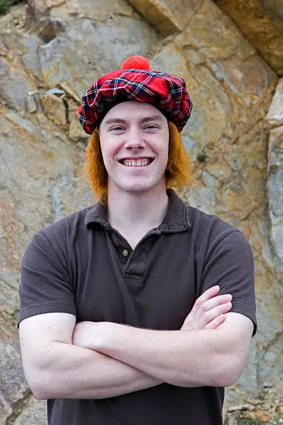 A young man wearing a tam o'shanter with red hair