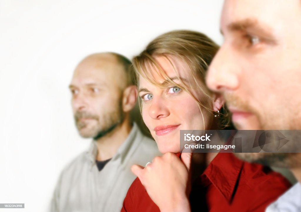 Portrait of three co-workers. A portrait of 3 people with focus on the woman. Human Face Stock Photo