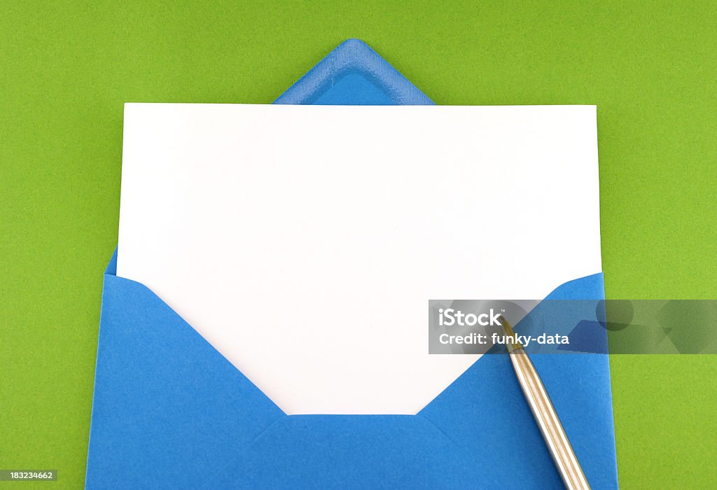 Blank greeting card in blue envelope A blank greeting card with copy space in a blue envelope isolated on green background. You may also be interested in Anniversary Stock Photo