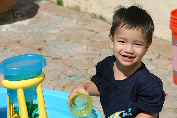 Outdoor fun with plastic play things stock photo