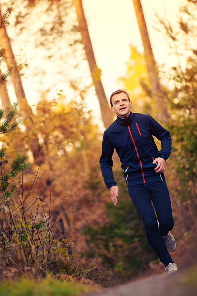 istock Man running in autumn trail 183234895