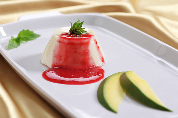 Panna cotta dessert with sweet sauce (strawberry) and mint. stock photo