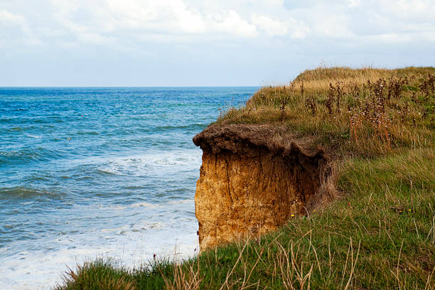 Rock-Studded Beach Beneath a Cliff in Tunisia. North Africa