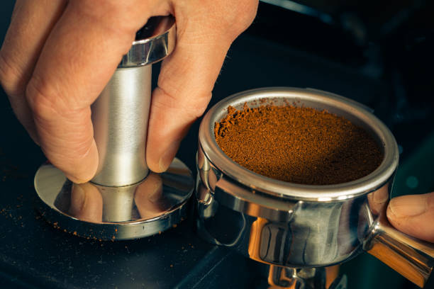istock Tamping ground coffee in a portafilter 1832351471