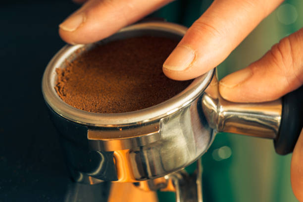 istock Tamping ground coffee in a portafilter 1832353167