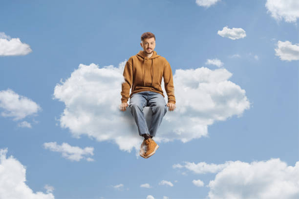 istock Guy in a jeans and hoodie sitting on a cloud 1832355859