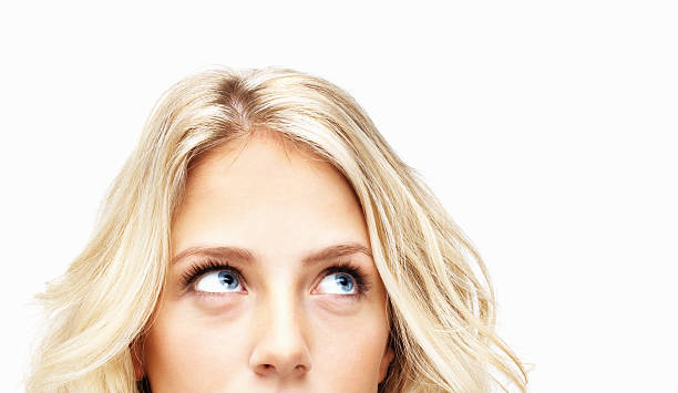 istock Young female looking away against white background 183235961