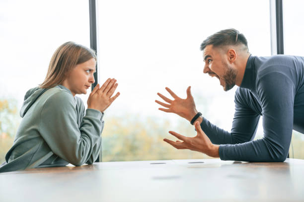 istock Side view, near big window. Man is screaming at his girlfriend, conception of quarrel 1832360182