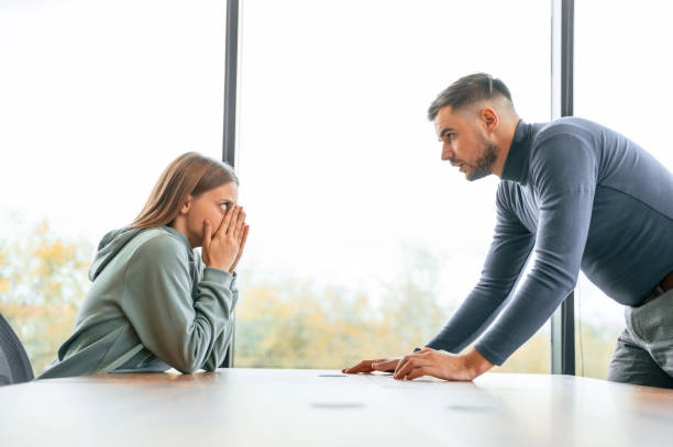 istock Side view, near big window. Man is screaming at his girlfriend, conception of quarrel 1832360183