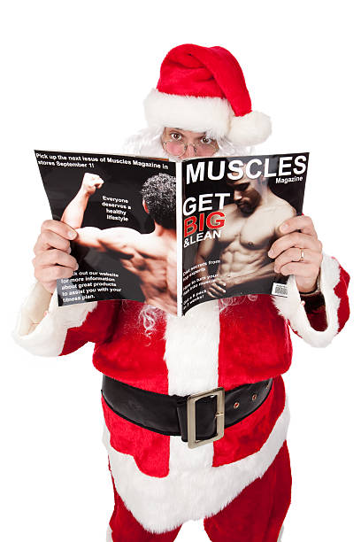 Santa reading a fitness magazine.  Fictitious magazine was created by photographer. Images featured on magazine: File #1667144 & 1745058.