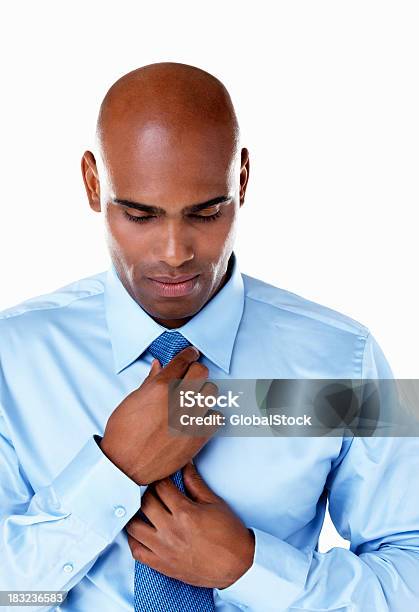 African American Business Man Adjusting Tie Against White Stock Photo - Download Image Now