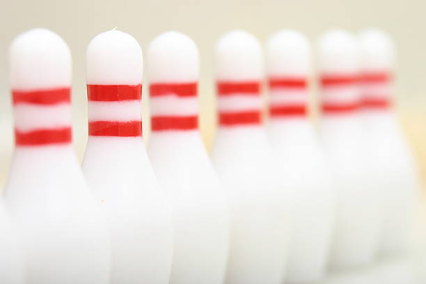 a row of bowling pin miniatures stock photo