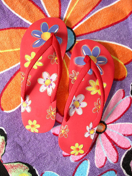 istock Thong sandals on beach towel 183237082