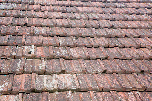 The roof is made of old vintage ceramic tiles. The texture of the background architectural details.