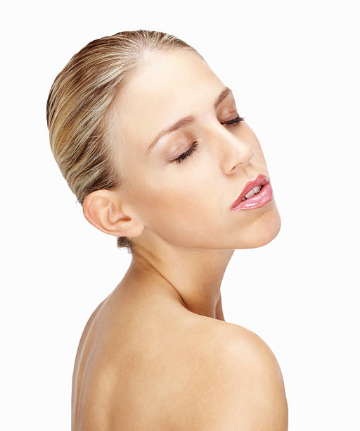 istock Topless young woman with eyes closed against white 183237556