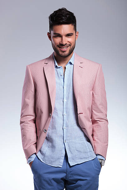 istock casual man smiles with hands in pockets 183238079