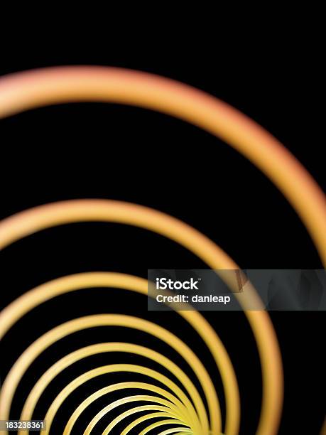 Slinky Stock Photo - Download Image Now - Black Background, Circle, Close-up