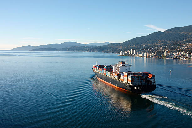 Container Ship Aerial photo of a loaded container ship leaving port. vancouver canada stock pictures, royalty-free photos & images