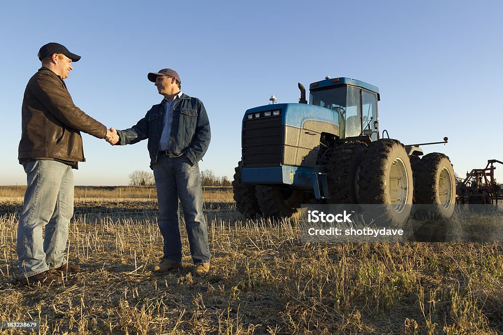 Farmer's Handshake A royalty free image from the farming industry of two farmers shaking hands at dusk. Farmer Stock Photo