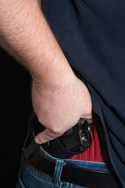 istock Concealed Carry Firearm Drawn From an Inside-the-Waistband Holster 183239012