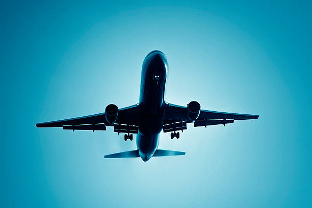 istock Approaching Airplane head lights on, flying through morning fog 183239661