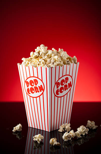Portrait of a movie theater popcorn box overflowing stock photo
