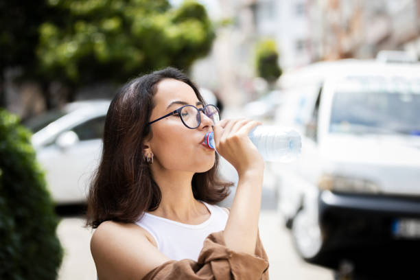 istock Young woman is drinking water. 1832407829
