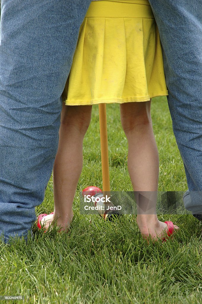 Croquet Assistance dad helping 5 year old take a croquet shot Arts Culture and Entertainment Stock Photo