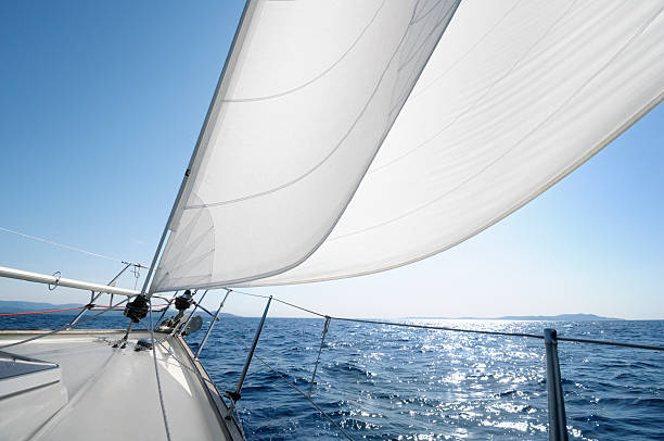 Sailing towards the horizon on a sunny day "White sails of a yacht billowing in the wind, French Riviera." french riviera photos stock pictures, royalty-free photos & images