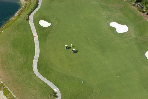 An aerial view of a golfer on a fairway.  Taken from a helicopter at 400 feet.