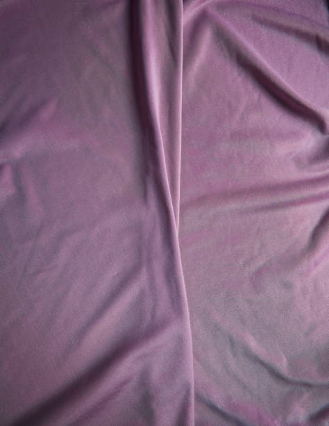 istock The fabric is pale pink with a matte surface. A crease in the middle. Texture 1832413607