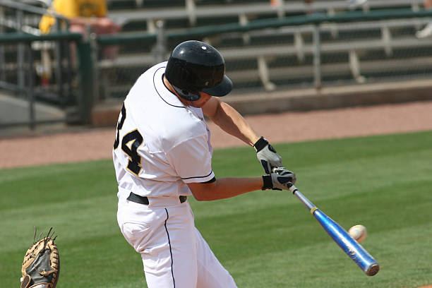 istock Baseball player hitting a ball with his bat on the field 183242246