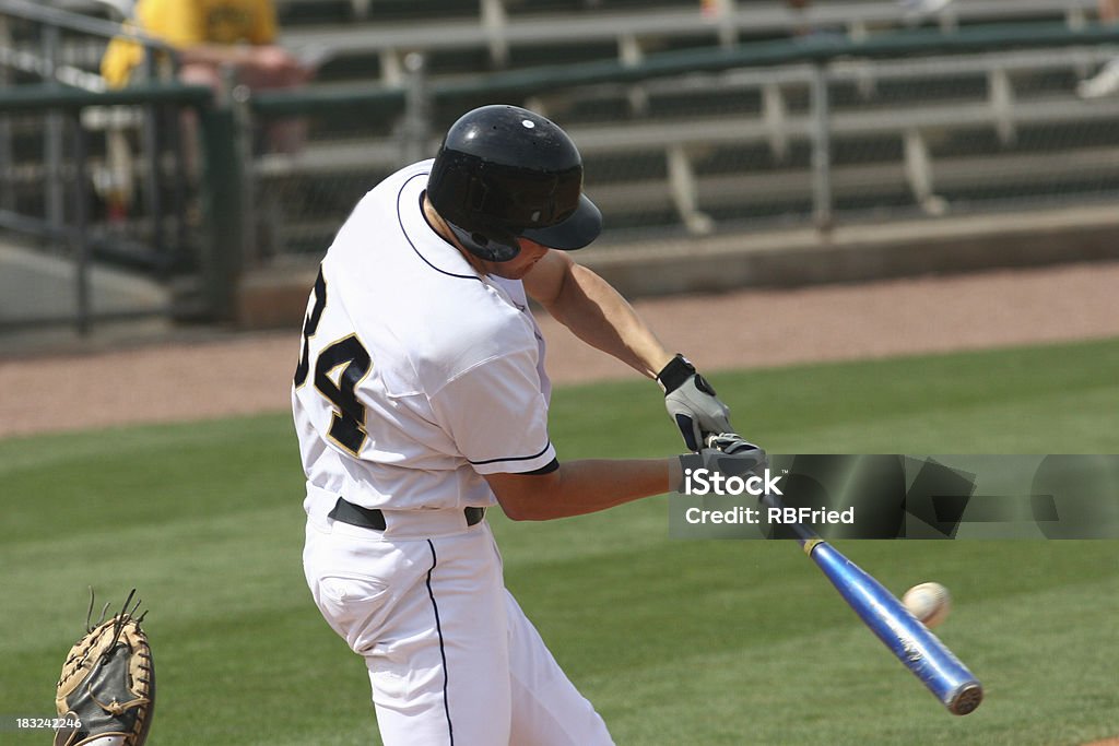 Baseball player hitting a ball with his bat on the field a hitter hitting a baseball Baseball Player Stock Photo